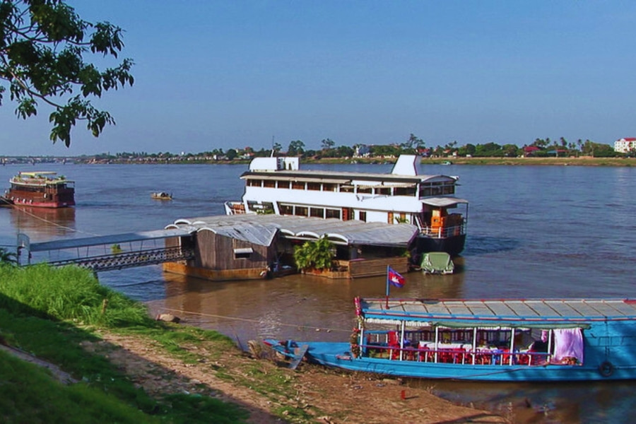 Mekong Delta river cruises with traditional boats at riverside port by Auasia Travel